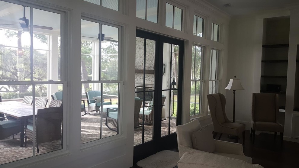 This is an example of a medium sized beach style open plan games room in San Diego with white walls, dark hardwood flooring, no fireplace and a built-in media unit.