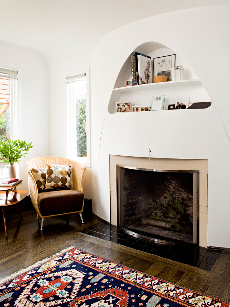 Design ideas for an eclectic living room in Portland with white walls, dark hardwood floors and a standard fireplace.
