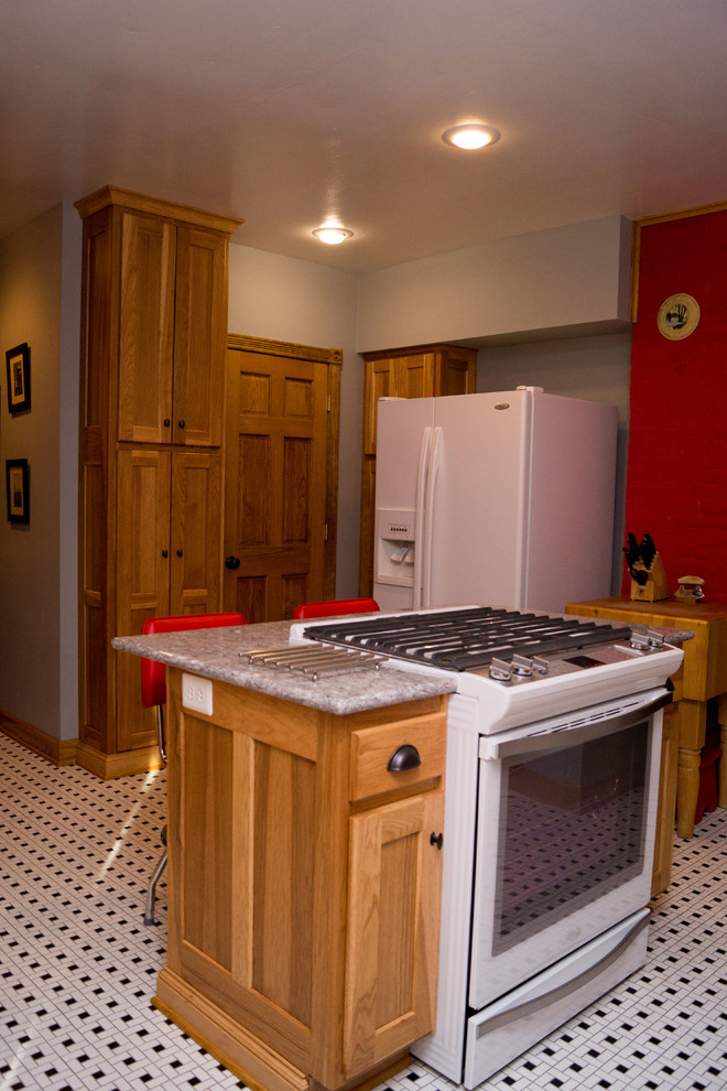 Inspiration for a mid-sized victorian ceramic tile enclosed kitchen remodel with an undermount sink, shaker cabinets, light wood cabinets, granite countertops, white backsplash, ceramic backsplash, white appliances and an island