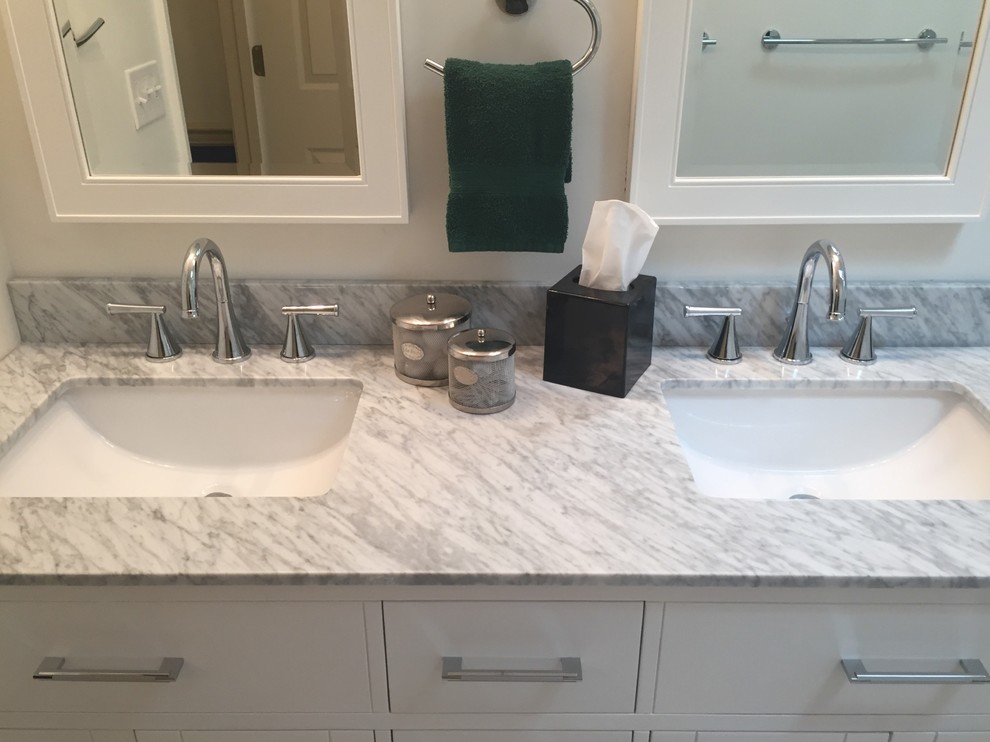 Example of a mid-sized transitional gray tile and porcelain tile porcelain tile home design design in Indianapolis with flat-panel cabinets, white cabinets, a one-piece toilet, white walls, an undermount sink and marble countertops