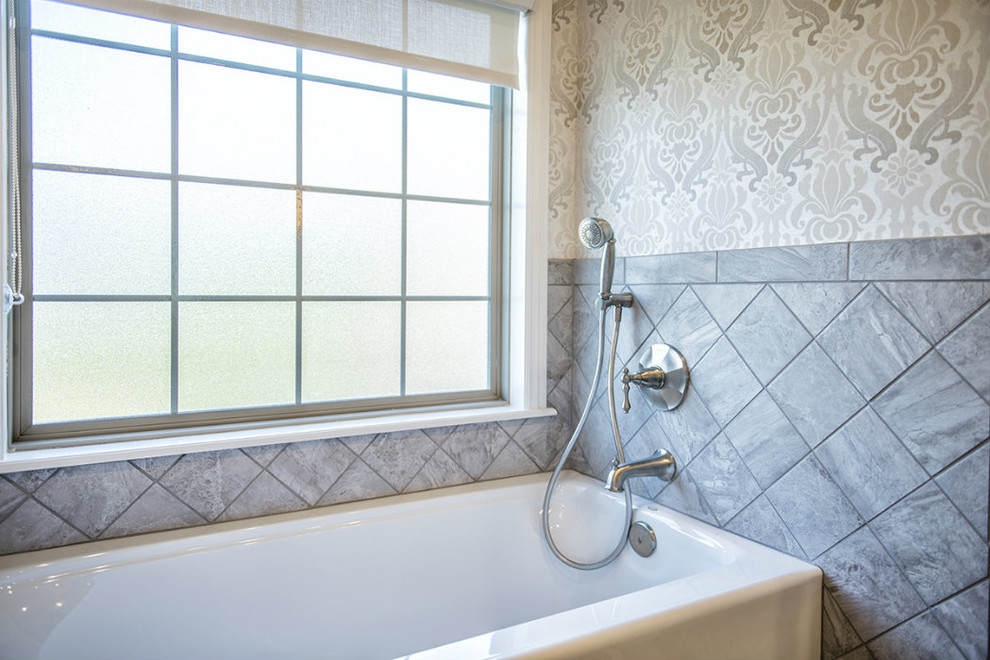 Example of a large transitional master gray tile and porcelain tile alcove bathtub design with gray walls