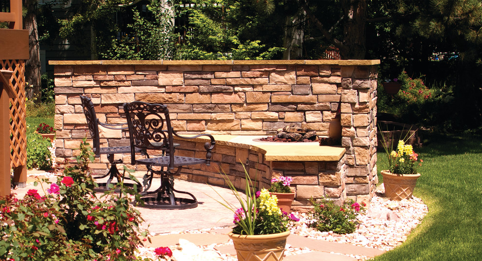 Mid-sized backyard concrete paver patio photo in Denver with a fire pit and no cover