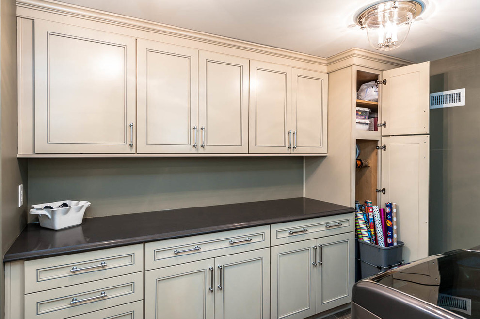 Inspiration for an expansive traditional galley utility room in Indianapolis with beige cabinets, quartz benchtops, a side-by-side washer and dryer, an undermount sink, grey walls, porcelain floors and recessed-panel cabinets.