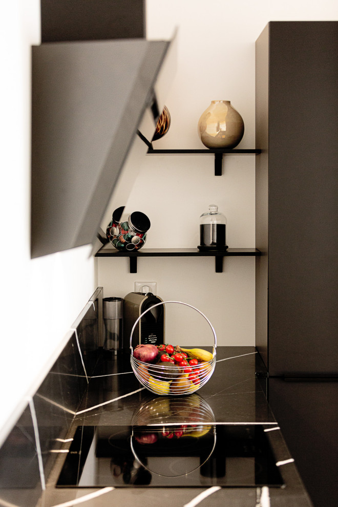Large minimalist u-shaped brown floor open concept kitchen photo in Other with a single-bowl sink, quartz countertops, black backsplash, quartz backsplash, paneled appliances, no island and black countertops