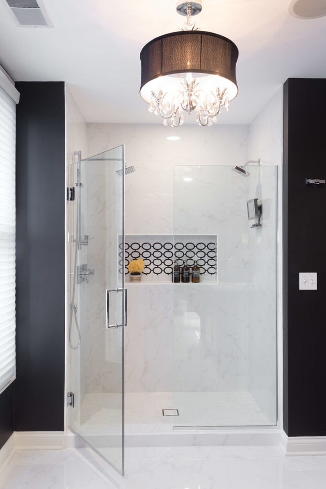 Inspiration for a mid-sized transitional master bathroom in Chicago with medium wood cabinets, a drop-in tub, an alcove shower, a one-piece toilet, black and white tile, porcelain tile, black walls, marble floors, an undermount sink, marble benchtops and beaded inset cabinets.