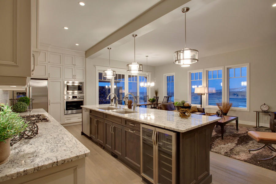 Mid-sized transitional l-shaped light wood floor open concept kitchen photo in Calgary with an undermount sink, recessed-panel cabinets, dark wood cabinets, granite countertops, white backsplash, ceramic backsplash, stainless steel appliances and an island