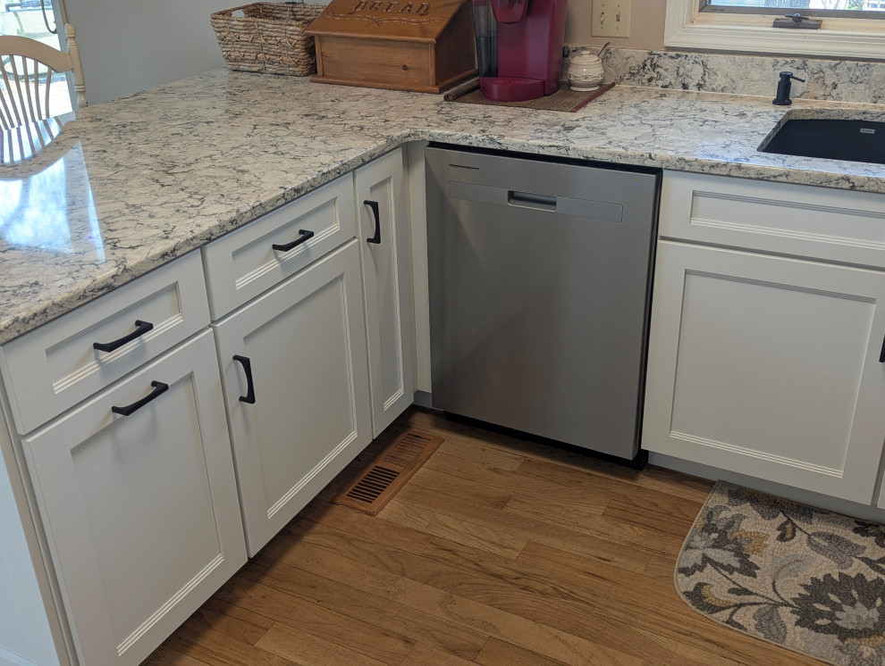 Inspiration for a small transitional u-shaped eat-in kitchen remodel with flat-panel cabinets