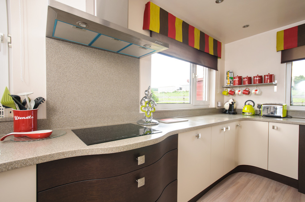 Design ideas for a small contemporary galley separate kitchen in Other with an integrated sink, beige cabinets, wood benchtops, multi-coloured splashback, stainless steel appliances and no island.
