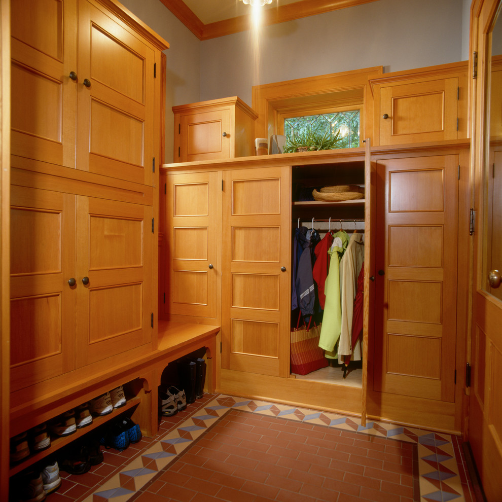 Design ideas for a traditional mudroom in Minneapolis with grey walls and ceramic floors.