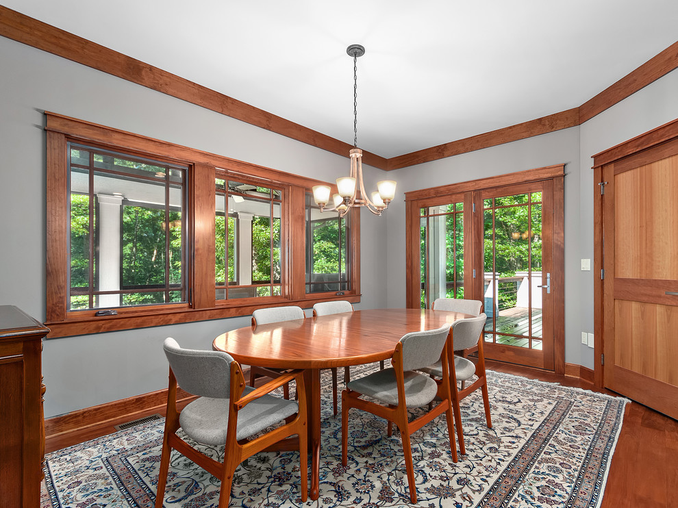 Inspiration for a mid-sized rustic dark wood floor and brown floor enclosed dining room remodel with gray walls