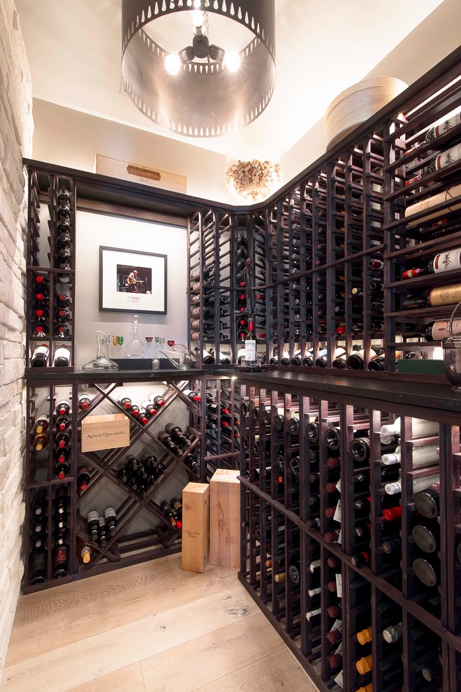 Photo of a transitional wine cellar in Austin.