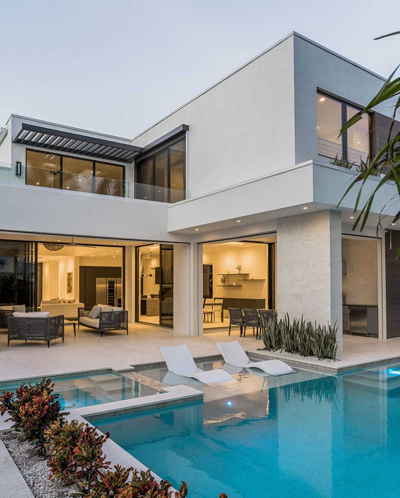 Inspiration for a white contemporary two floor detached house in Miami with a flat roof.