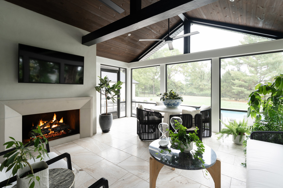 Sunroom - large traditional travertine floor sunroom idea in Other with a standard fireplace