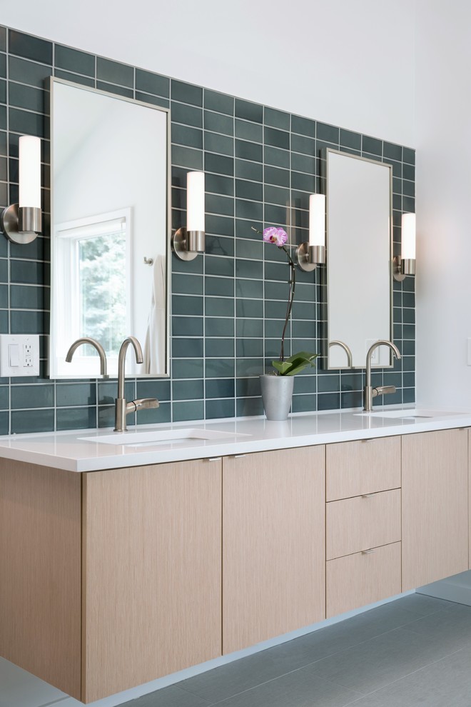 Photo of a contemporary master bathroom in Denver with flat-panel cabinets, light wood cabinets, ceramic tile, porcelain floors, an undermount sink, engineered quartz benchtops, blue tile, white walls and grey floor.