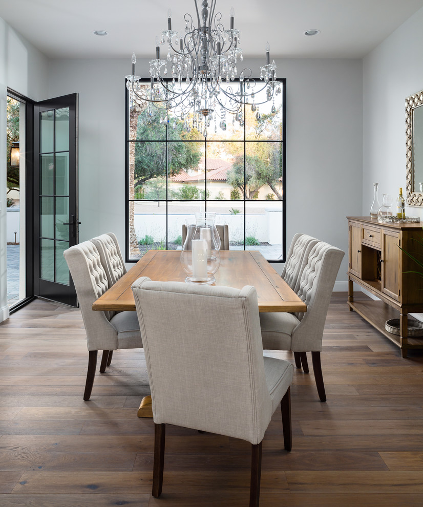 Design ideas for a mediterranean dining room in Phoenix with grey walls, medium hardwood floors and brown floor.