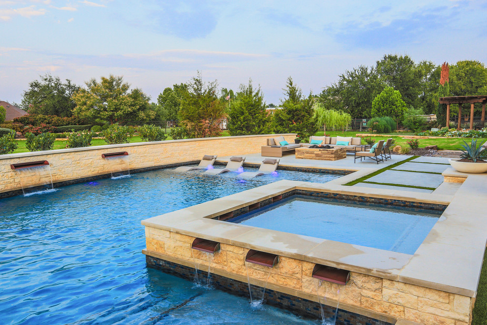 Photo of a large contemporary backyard l-shaped pool in Dallas with concrete slab and a water feature.