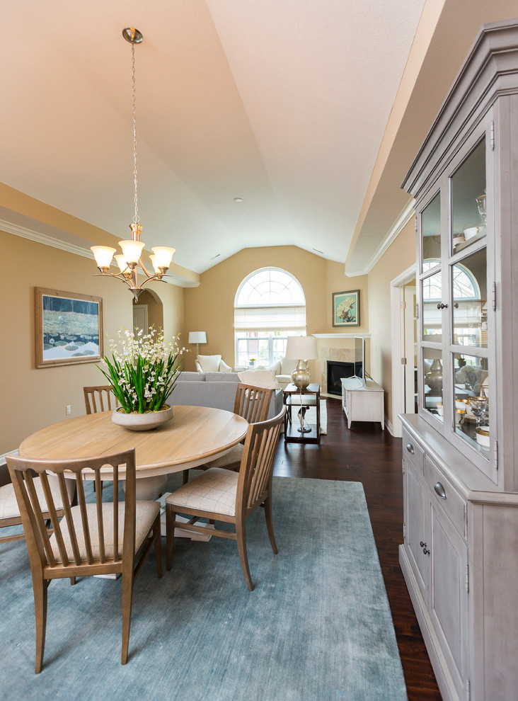 Mid-sized transitional dark wood floor kitchen/dining room combo photo in Cincinnati with beige walls and a corner fireplace