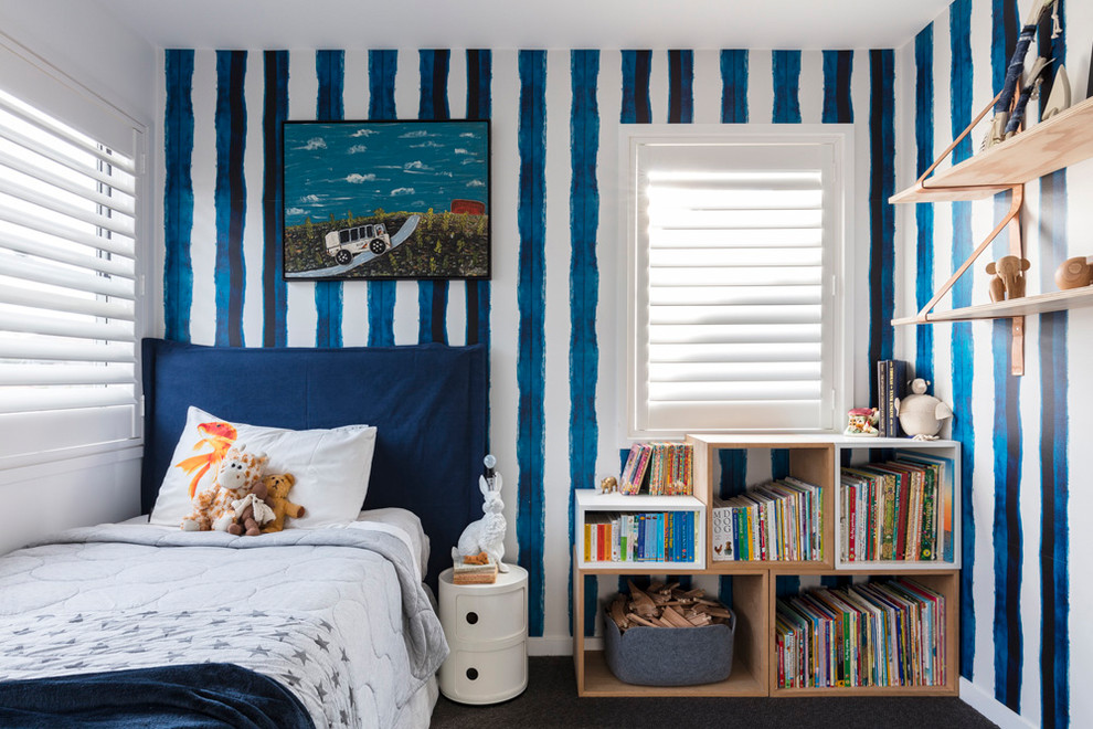 This is an example of a mid-sized contemporary nursery for boys in Sydney with blue walls, carpet and grey floor.