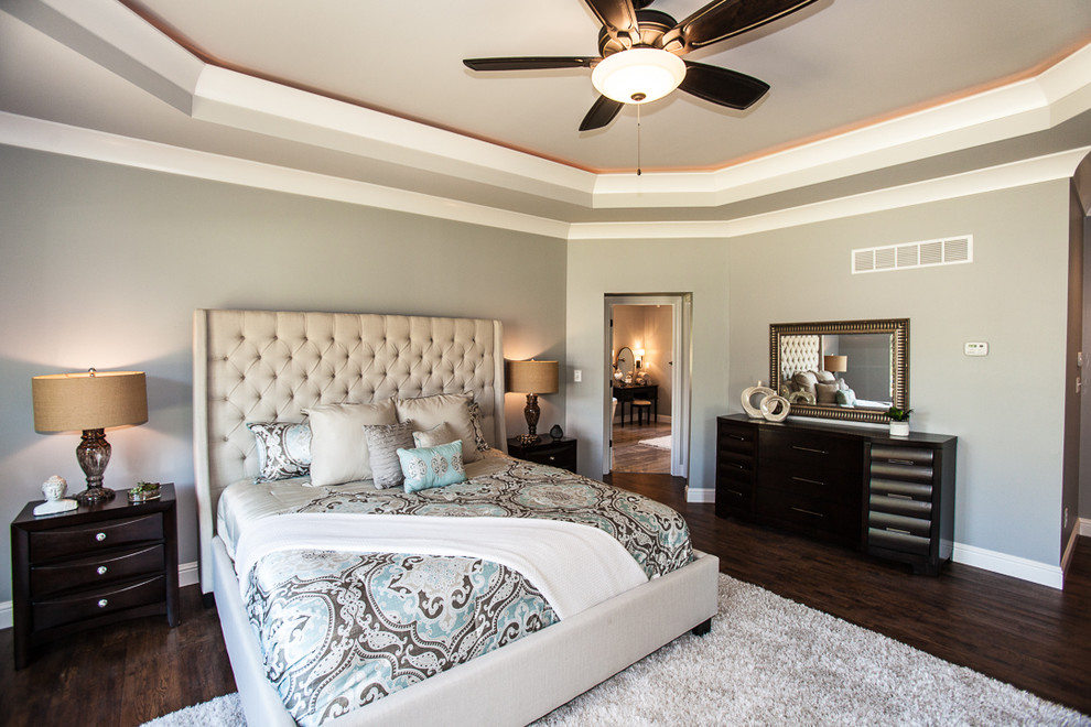 Photo of a large transitional master bedroom in St Louis with grey walls and dark hardwood floors.