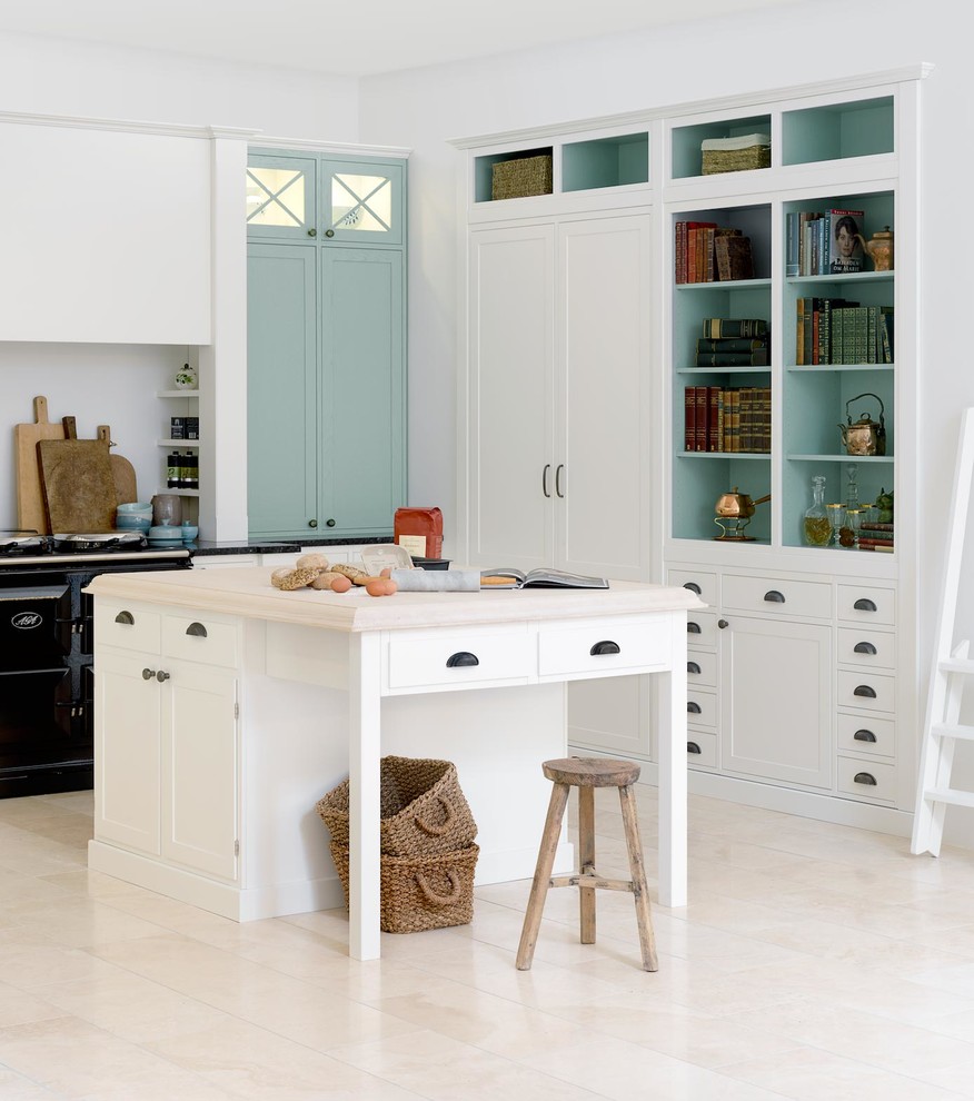 This is an example of a country kitchen in Aalborg with with island and beige floor.