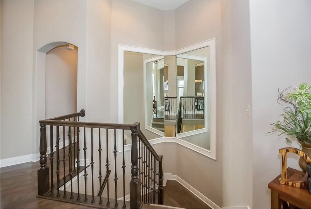 Mid-sized transitional wood u-shaped staircase in Kansas City with mixed railing.