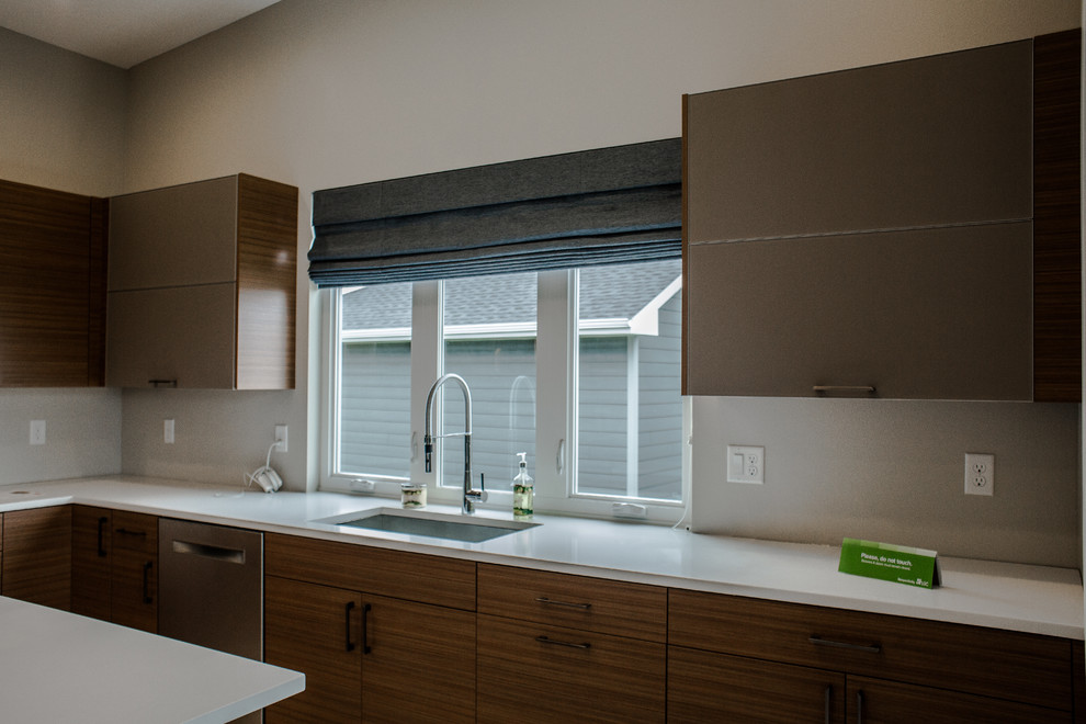 Inspiration for a mid-sized modern kitchen remodel in Cedar Rapids with an undermount sink, flat-panel cabinets, dark wood cabinets, quartzite countertops, white backsplash, stainless steel appliances and an island