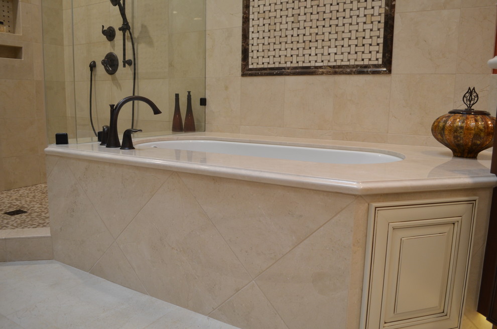 Inspiration for a large traditional master bathroom in Phoenix with an undermount sink, raised-panel cabinets, dark wood cabinets, marble benchtops, an undermount tub, a double shower, a bidet, beige tile, stone tile, orange walls and porcelain floors.