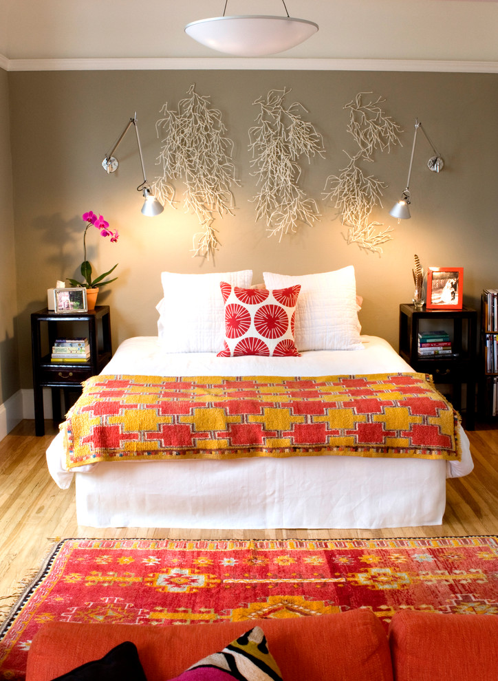 Eclectic bedroom in San Francisco with grey walls and medium hardwood floors.