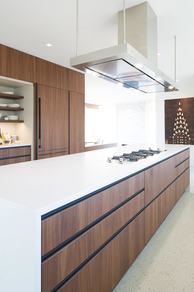 Inspiration for a large modern galley eat-in kitchen in Richmond with an undermount sink, flat-panel cabinets, medium wood cabinets, quartz benchtops, white splashback, stone slab splashback, black appliances, terrazzo floors, with island and white benchtop.