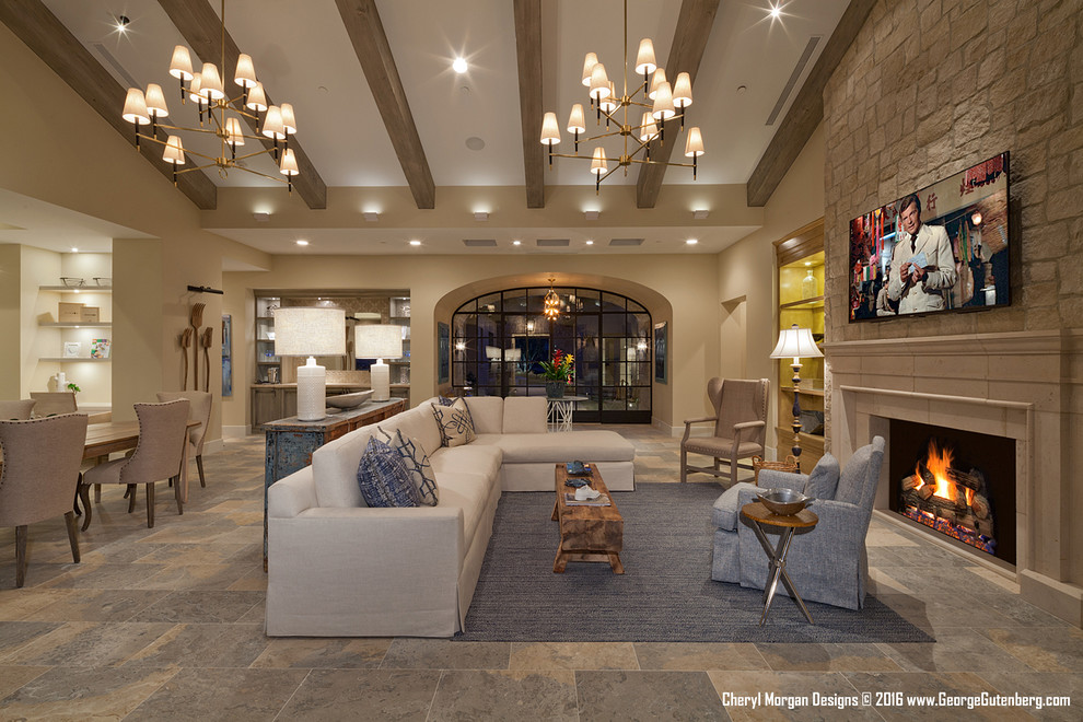Design ideas for an expansive country open concept living room in Los Angeles with a home bar, beige walls, travertine floors, a standard fireplace, a stone fireplace surround and a wall-mounted tv.