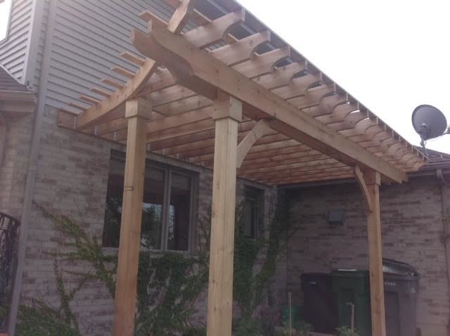 Photo of a traditional backyard patio in Chicago with decking and a pergola.