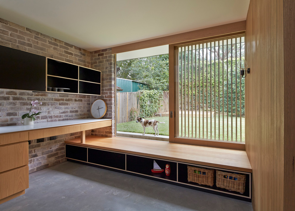 Design ideas for a small contemporary gender-neutral kids' playroom for kids 4-10 years old in Sydney with concrete floors.