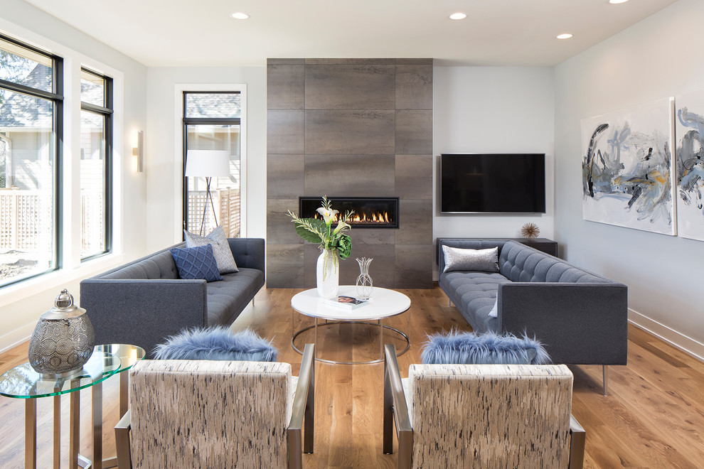 Inspiration for a mid-sized contemporary formal open concept living room in Minneapolis with light hardwood floors, a ribbon fireplace, a tile fireplace surround and a wall-mounted tv.
