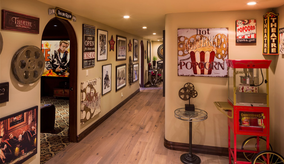 This is an example of an eclectic hallway in Phoenix with beige walls and light hardwood floors.