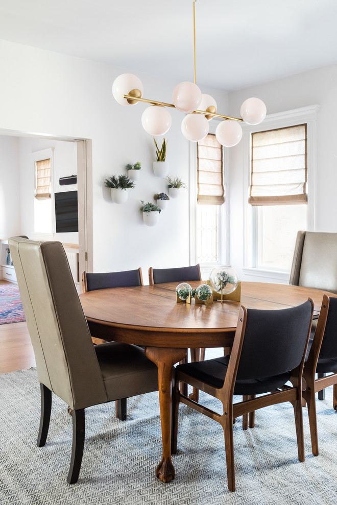 Design ideas for a contemporary dining room in Boston with white walls, medium hardwood floors and brown floor.