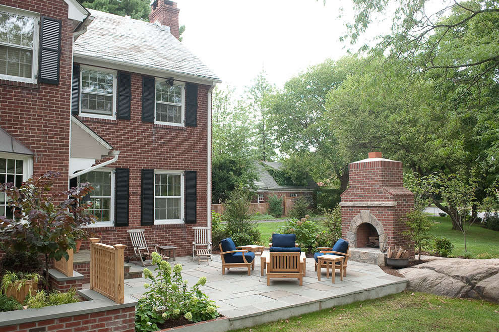 Design ideas for an eclectic backyard patio in New York with natural stone pavers.