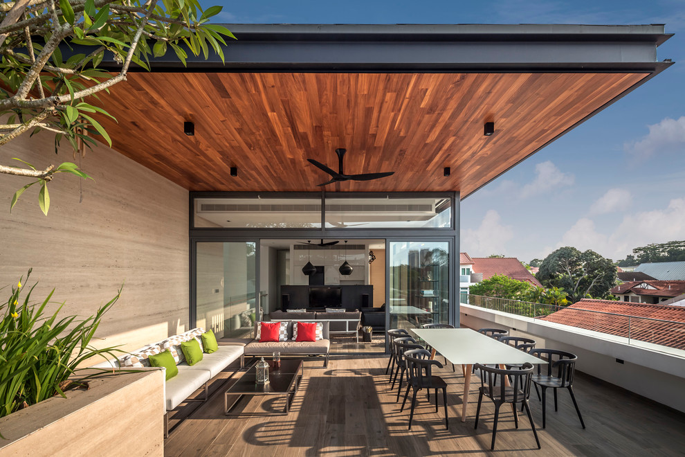 Contemporary deck in Singapore with a roof extension.