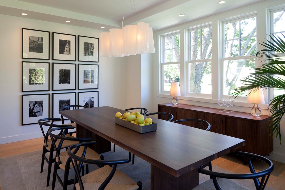 Photo of a contemporary dining room in Minneapolis with white walls and dark hardwood floors.