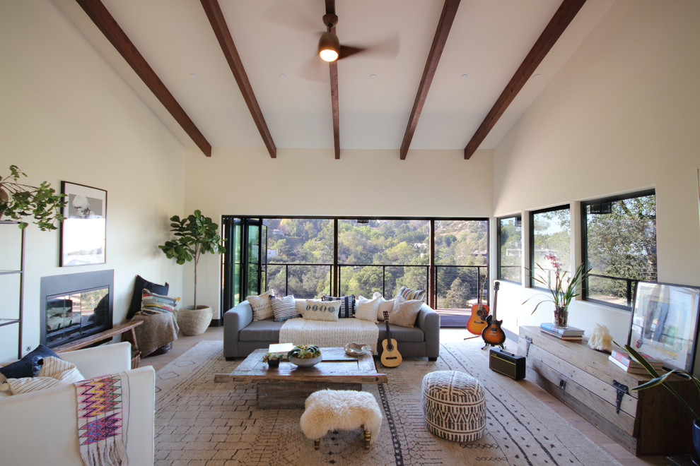 Photo of a mid-sized country formal open concept living room in Los Angeles with white walls, light hardwood floors and beige floor.