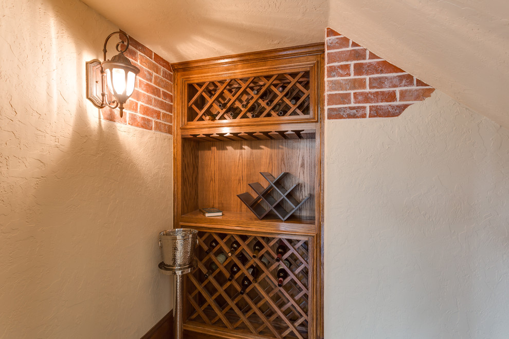 This is an example of a small transitional wine cellar in Dallas with medium hardwood floors and diamond bins.