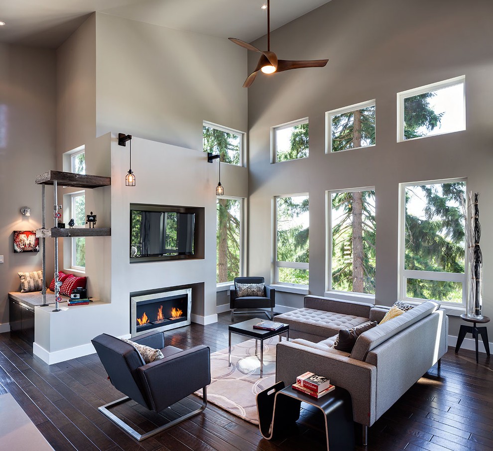 Large contemporary open concept living room in Portland with grey walls, a wall-mounted tv, dark hardwood floors and a ribbon fireplace.