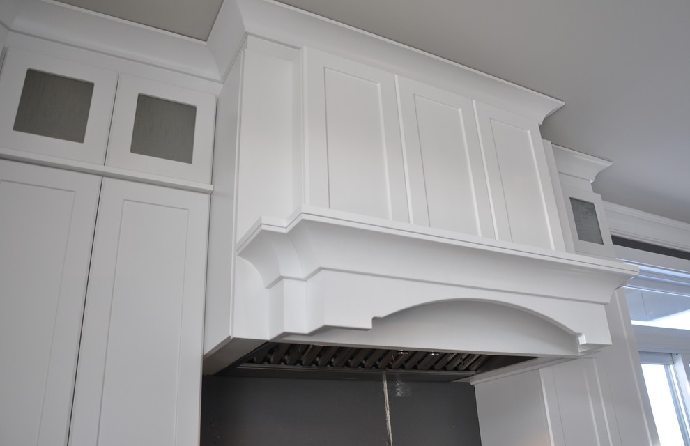 Example of a large transitional l-shaped ceramic tile enclosed kitchen design in Ottawa with an undermount sink, shaker cabinets, white cabinets, granite countertops, stainless steel appliances and an island