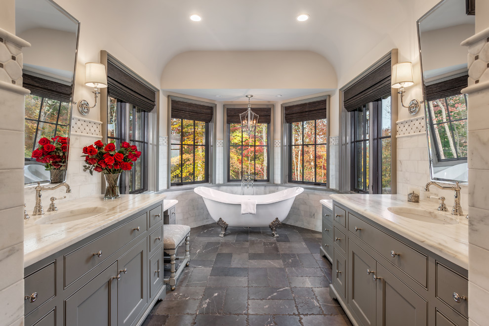 Design ideas for a large transitional master bathroom in Other with recessed-panel cabinets, grey cabinets, a claw-foot tub, white walls, an undermount sink, grey floor, stone tile, limestone floors and marble benchtops.