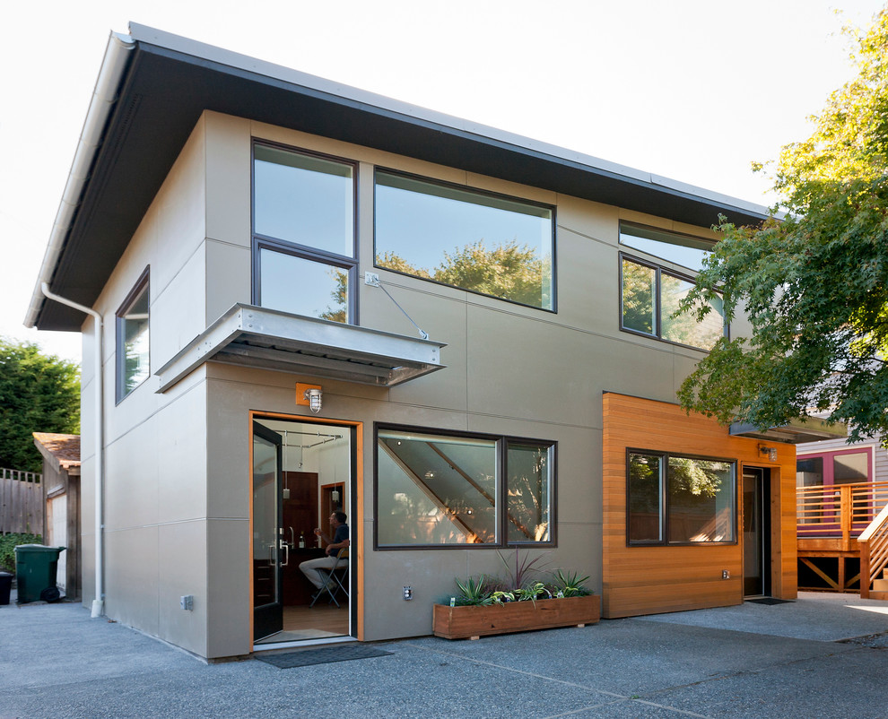 Design ideas for a mid-sized contemporary exterior in Seattle with concrete fiberboard siding and a shed roof.