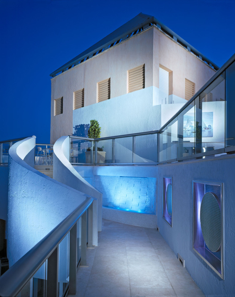 Design ideas for a contemporary stucco exterior in Miami.