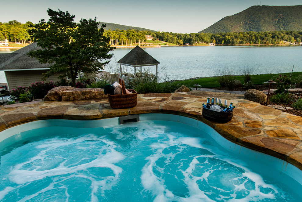 Inspiration for a backyard stone pool remodel with a fire pit
