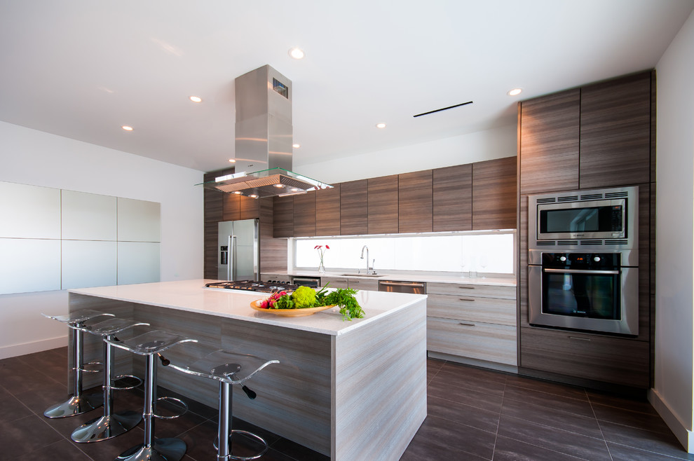 Contemporary single-wall eat-in kitchen in Houston with flat-panel cabinets, grey cabinets, quartz benchtops, yellow splashback, glass sheet splashback and stainless steel appliances.