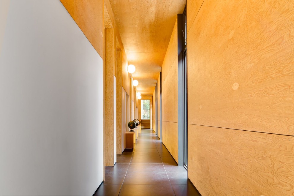 Photo of an expansive midcentury hallway in Toronto with porcelain floors.