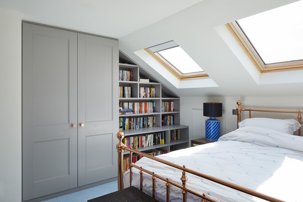 This is an example of a small traditional bedroom in London with white walls and blue floor.