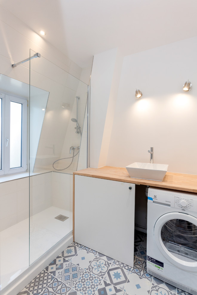 Small contemporary master bathroom in Paris with flat-panel cabinets, white cabinets, a curbless shower, white tile, ceramic tile, white walls, cement tiles, a drop-in sink, wood benchtops, blue floor and white benchtops.